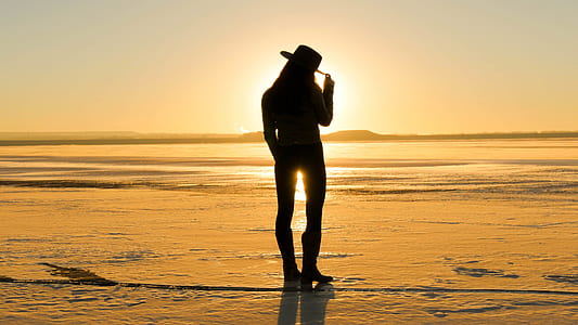 silhouette of cowgirl during golden hour thumbnail