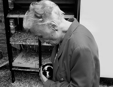 greyscale photography of woman standing near the rack thumbnail