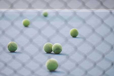 green tennis balls through fence thumbnail