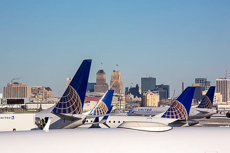 several airplanes with high-rise building at distance thumbnail