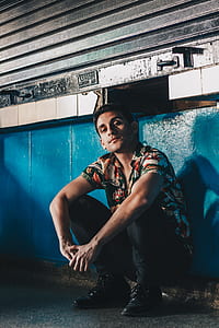 man sitting on concrete floor thumbnail