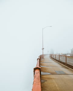 empty bridge covered with fog at daytime thumbnail