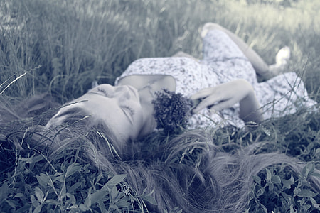 woman laying on grass field thumbnail