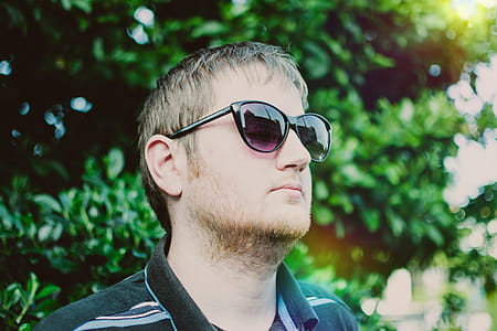 Man Wearing Black Sunglasses and Polo Shirt thumbnail