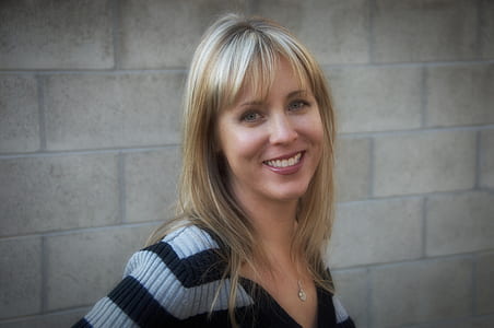 woman in gray and black striped top taking selfie thumbnail