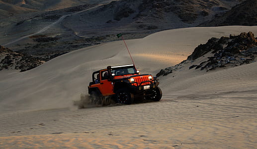 Red Jeep Wrangler on White Covered Field thumbnail