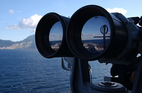 person looking through glasses near body of water thumbnail