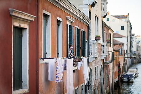 woman looking outside from building terrace thumbnail