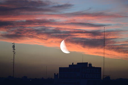 silhouette of building and half moon thumbnail