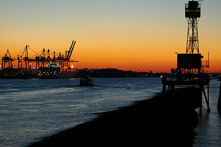 silhouette of boats on body of water thumbnail