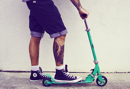 person rides on teal kick scooter thumbnail