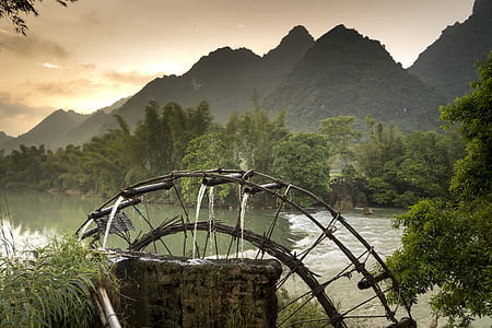 watermill surround by mountains during daytime thumbnail
