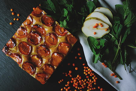 square pastry beside green leaves with sliced fruit thumbnail