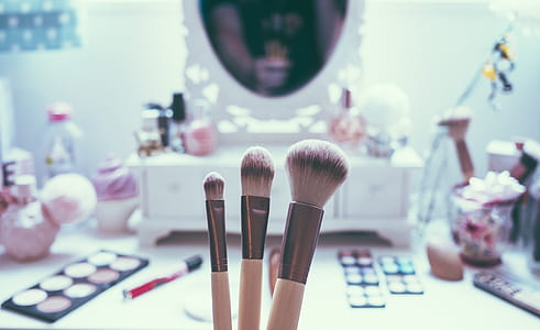 three makeup brushes near makeup palette thumbnail