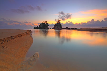calm water near rock and sand thumbnail