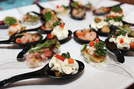 appetizers served in black spoons thumbnail