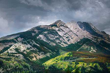 mountain near on grass field thumbnail