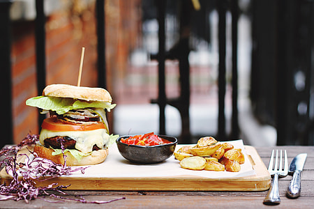 burger beside black bowl on brown wooden board thumbnail