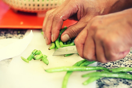 person slicing beans on chopping board thumbnail
