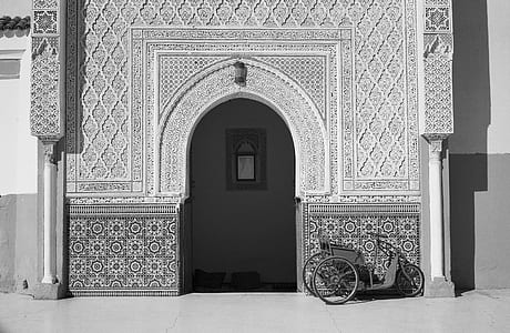 trike in front of commercial building grayscale photography thumbnail