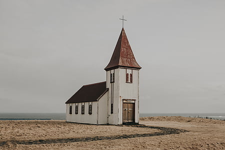 white and brown church surrounded by body of water thumbnail