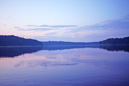 calm body of water near island during daytime thumbnail