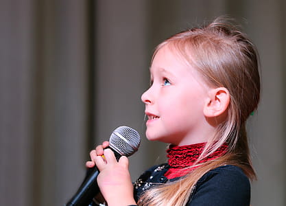 Girl Holding Black Dynamic Microphone While Looking Above thumbnail