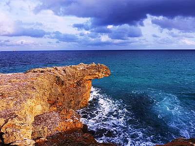 brown rock formation near the ocean photography thumbnail