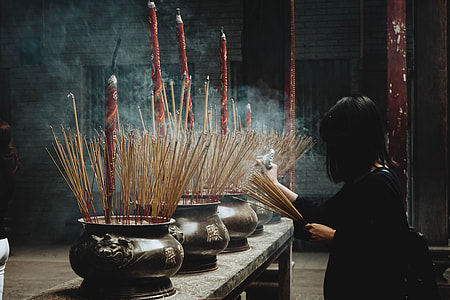 woman holding incense sticks thumbnail