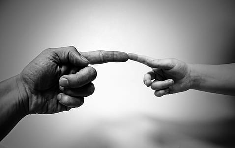grayscale photography of two index fingers of two persons thumbnail