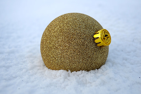 gold glitter bauble on white snow thumbnail
