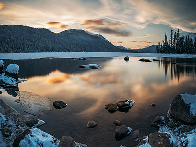 photography of lake beside mountain at daytime thumbnail
