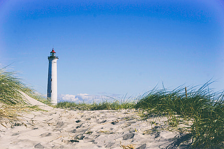 lighthouse under cumulus clouds thumbnail