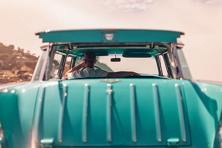 man inside blue vintage vehicle thumbnail