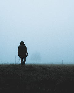 man walking on plain covered with fog thumbnail