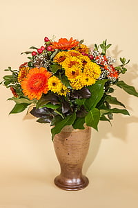 yellow and orange petaled flowers in vase thumbnail
