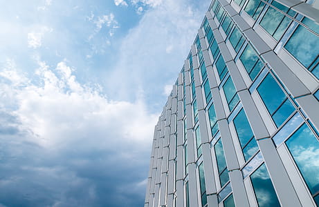 Amazing office building with windows. Blue sky with clouds after rain thumbnail