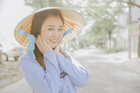 woman wearing cone-shaped hat and long-sleeved shirt thumbnail
