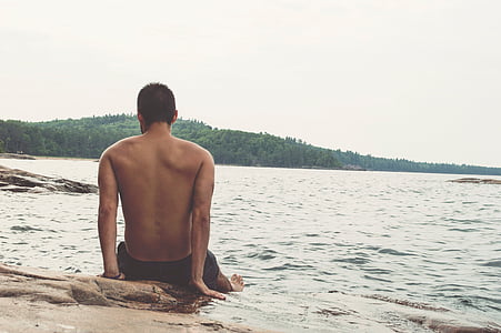 man sitting bear body of water thumbnail