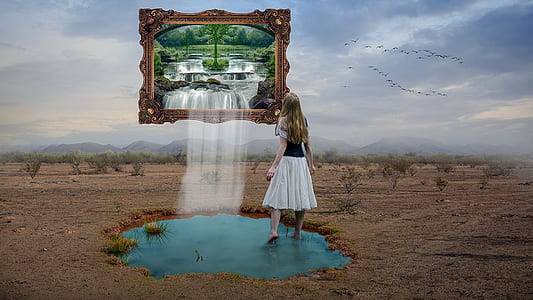 girl standing on body of water looking at framed waterfalls photo thumbnail