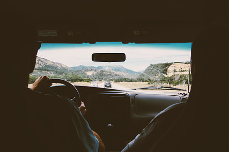 man steering vehicle's wheel thumbnail