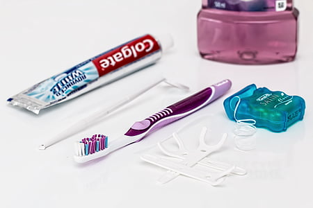 Colgate Advanced White collapsible bottle, white dental magnifier, white and pink toothbrush, and dental floss thumbnail