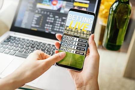 Close-up view of young woman betting with her mobile phone. thumbnail