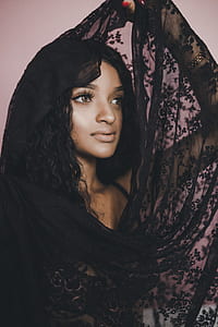 woman in black floral sheer scarf looking up thumbnail
