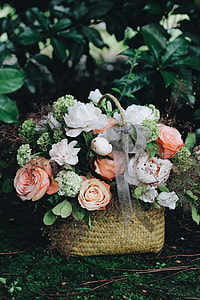 green, white, and pink petaled flowers in brown wicker basket thumbnail
