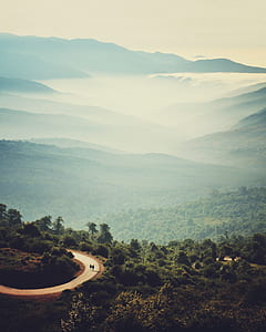 two person walking on road toward mountains thumbnail