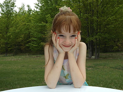 girl wearing pink and blue sleeveless mini dress near green leaf trees thumbnail