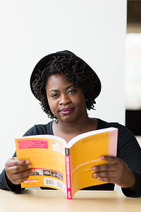 Woman With Black Hat Holding Book thumbnail