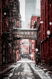 pathway between buildings during snow time thumbnail