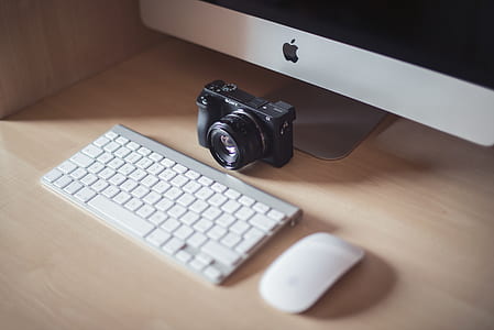 black DSLR camera near keyboard thumbnail